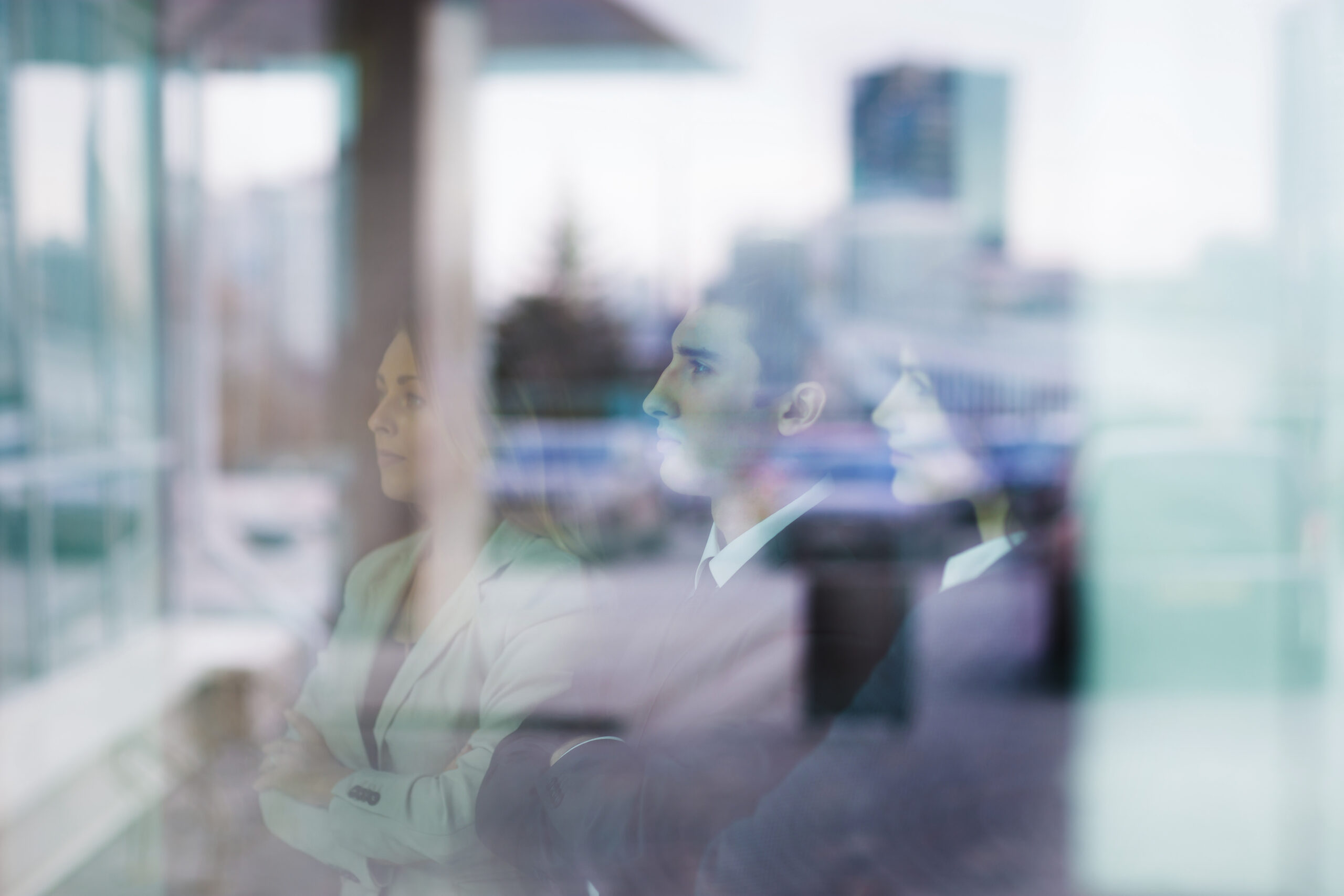 Successful business team stands in front of a window in a modern office